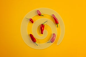 Red peppers on yellow background