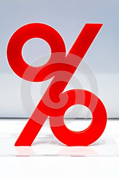 Red percentage icon on display in a store