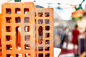 Red perforated bricks on the abstract background.