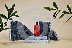 red perfume bottle on marble podium or showcase with ruscus plant