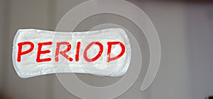 Red period inscription on panty liner or sanitary napkin. Puberty of girls and the period of women menstruation concept