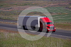 Red Peterbilt Semi-Truck / White Trailer