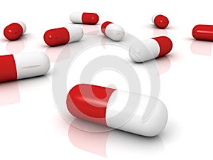 Red pharmaceutical capsules pills on white surface