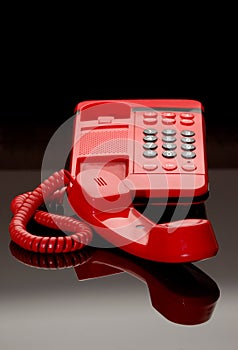 Red phone on black glass