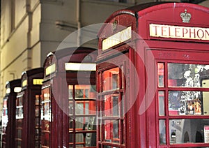 Red phone booths at night