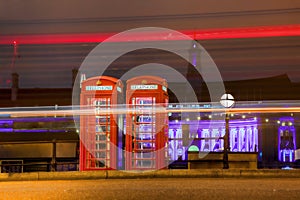 Red PHONE BOOTHS at night in London, England