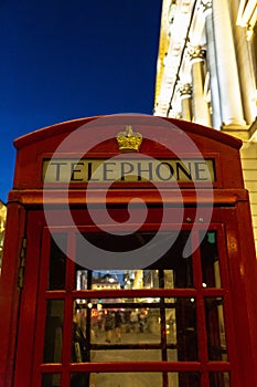Red phonebooth in London by night photo