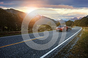 red pick up truck passing on asphalt highway at mount aspiring national park southland new zealand one of most popular traveling