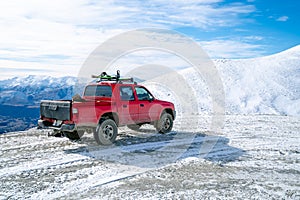 Red pickup truck on road, Beautiful winter road under snow mountains New Zealand