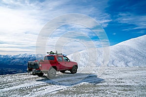 Red pickup truck on road, Beautiful winter road under snow mountains New Zealand