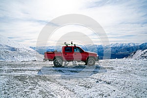 Red pickup truck on road, Beautiful winter road under snow mountains New Zealand