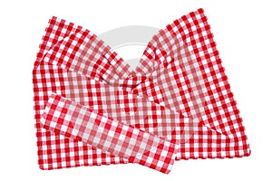 Red picnic blanket. Closeup of a red checkered napkin or tablecloth texture isolated on a white background. Beautiful backdrop for