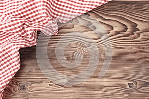 Red picnic cloth on wooden background