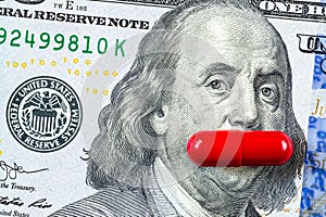 red pill covers Franklin& x27;s mouth on US hundred dollar bill. concept of potency, health, pill cost, men& x27;s health