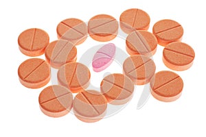 Red pill among orange favored lozenges photo