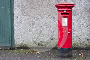 Red pillar post box for mail collection