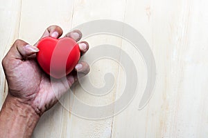 Red pillow heart in hand