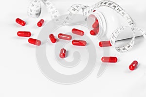 Red pills measuring tape Diet health detox concept
