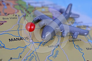 Red pin marked city Manaus on map with planeta, Brazil photo