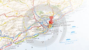 A red pin stuck in Barcelona on a map of Spain photo