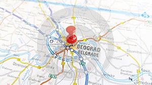 A red pin stuck in Belgrade on a map of Serbia