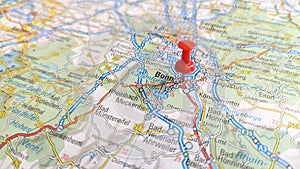 A red pin stuck in Bonn on a map of Germany