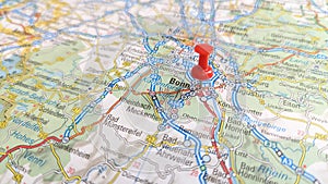 A red pin stuck in Bonn on a map of Germany photo