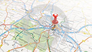 A red pin stuck Bremen on a map of Germany photo