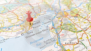 A red pin stuck in Cardiff on a map of Wales