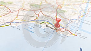 A red pin stuck in Cartagena on a map of Spain photo