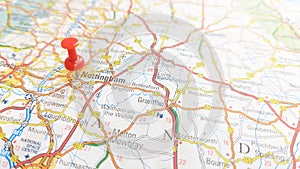 A red pin stuck into the city of Nottingham on a map of England photo