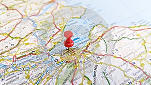 A red pin stuck in Edinburgh on a map of Scotland photo