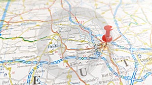 A red pin stuck in Halle on a map of Germany