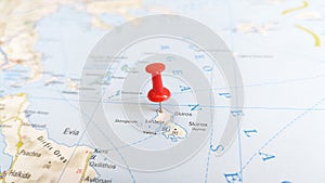A red pin stuck in the island of skyros skiros on a map of Greece photo