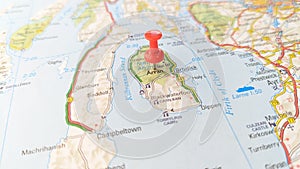 A red pin stuck in the Isle of Arran on a map of Scotland photo
