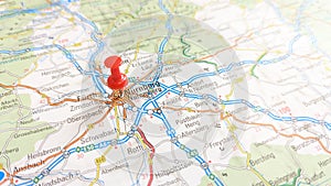 A red pin stuck in Nuremberg on a map of Germany