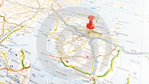 A red pin stuck in Odense on a map of Denmark