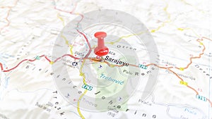 A red pin stuck in Sarajevo on a map of Bosnia and Herzegovina
