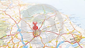 A red pin stuck in York on a map of England photo