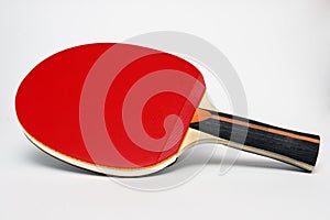 Red ping pong paddle on a white background