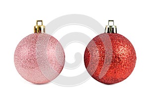 Red and pink christmas baubles on white background