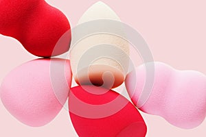 Red and pink cosmetic beauty sponges close up Makeup puff for tone cream, foundation, concealer