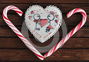 Red and pink heart-shaped cakes And heart-shaped lollipops on a wooden background