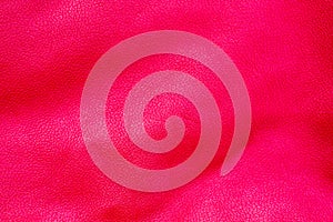Red pink leather surface under high magnification close detail photography with patterns and surface texture background