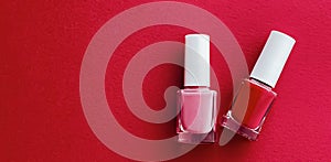 Red and pink nail polish bottles on red background, manicure and beauty cosmetics