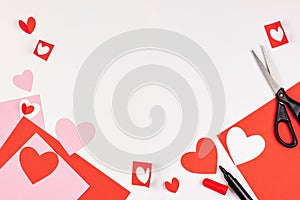 Red and pink paper hearts on white background. Valentine`s day, love, wedding concept