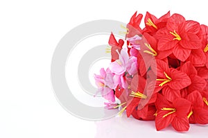 Red and pink plastic flowers Ioslated on white backgrounds