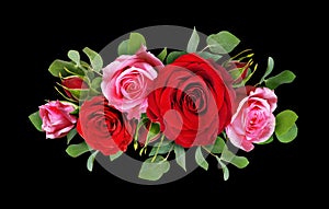 Red and pink rose flowers with eucalyptus leaves in a floral arr