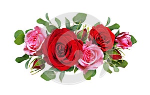 Red and pink rose flowers with eucalyptus leaves in a floral arr