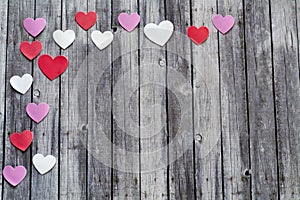 Red pink and white hearts on wood background